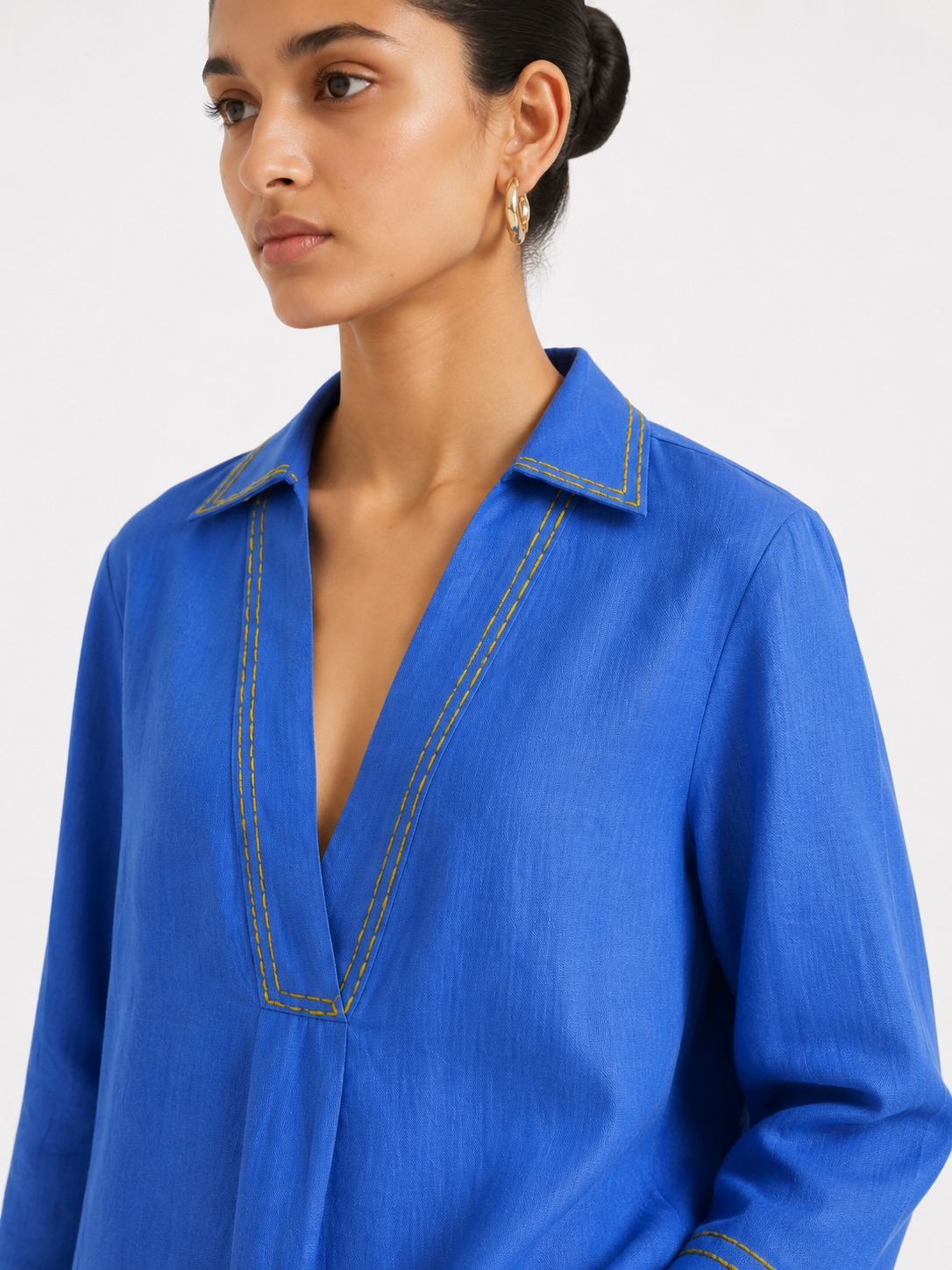 Close-up of Ziya linen top showing V-neck and lemon yellow chawal taka detailing