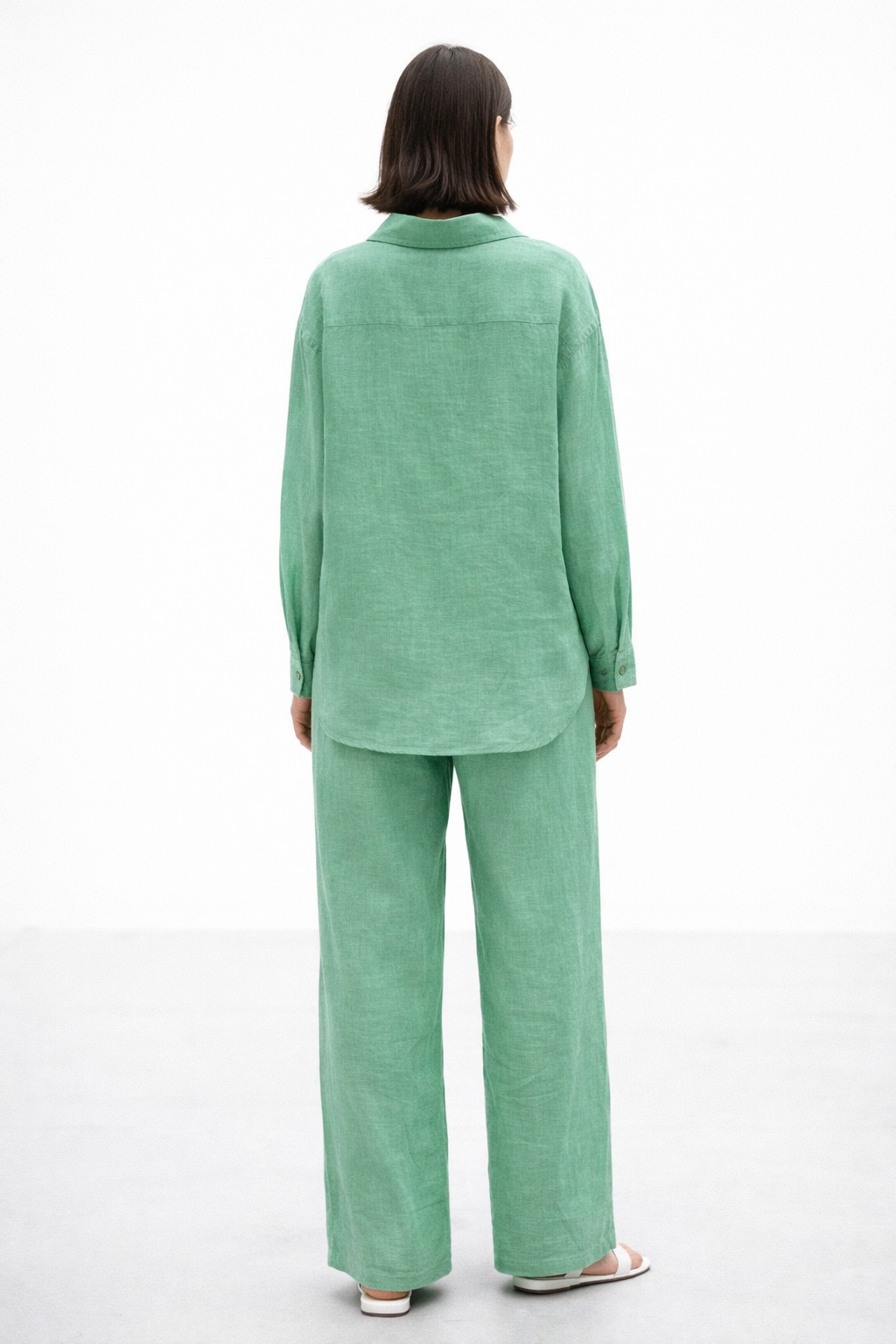 Back view of Aura Green Linen Set for women showing shirt length and relaxed linen silhouette