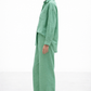 Side angle of Aura Green Linen Set for women highlighting wide-leg pants and fluid linen drape