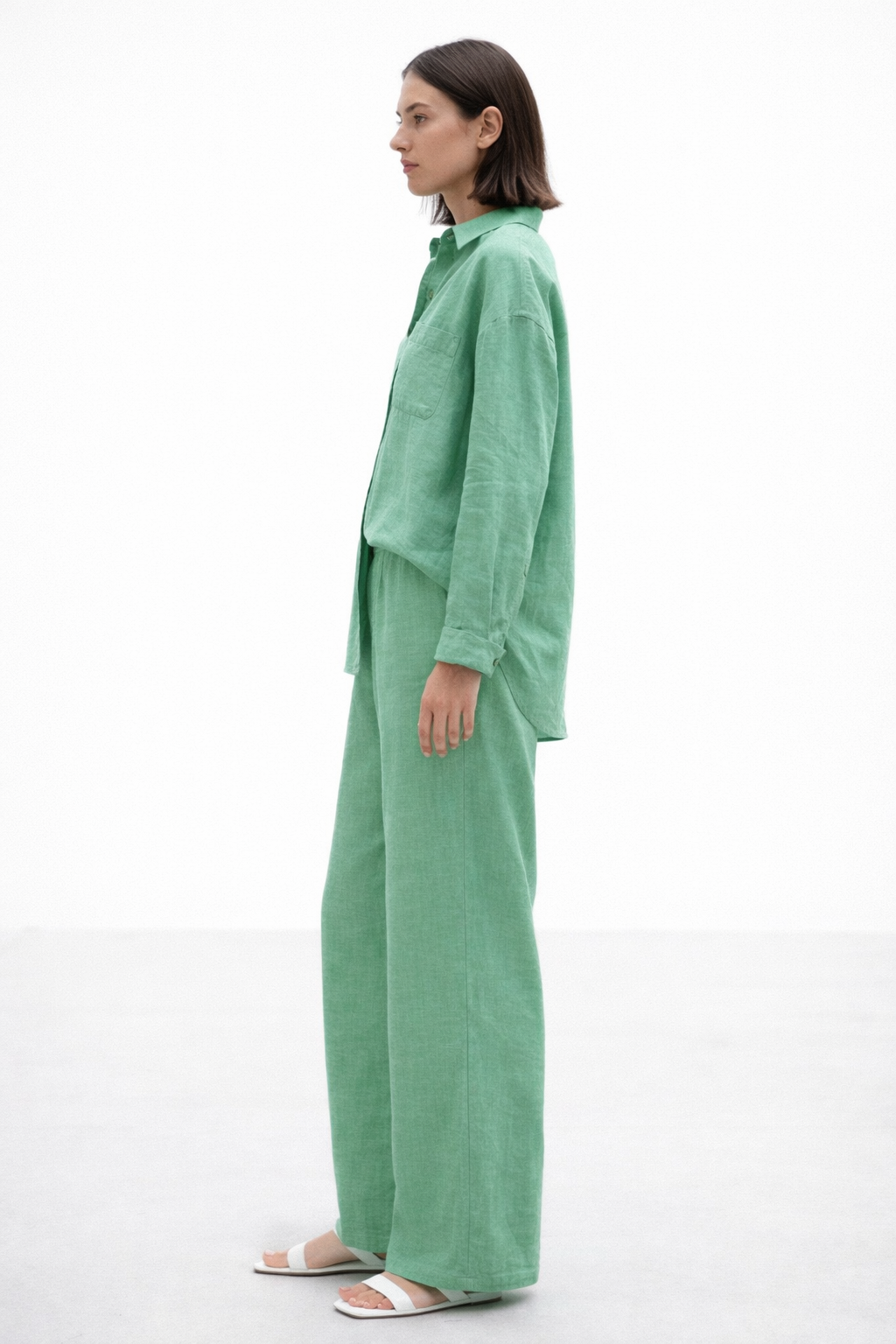 Side angle of Aura Green Linen Set for women highlighting wide-leg pants and fluid linen drape