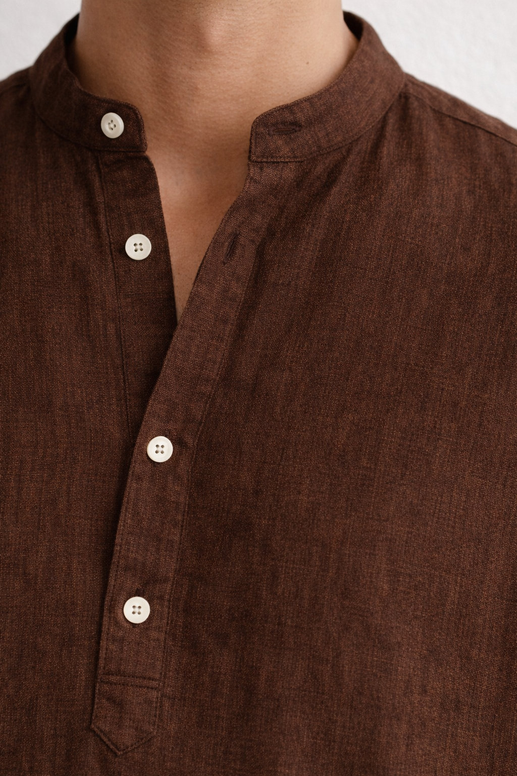 Close-up of pure linen fabric texture in chocolate brown kurta