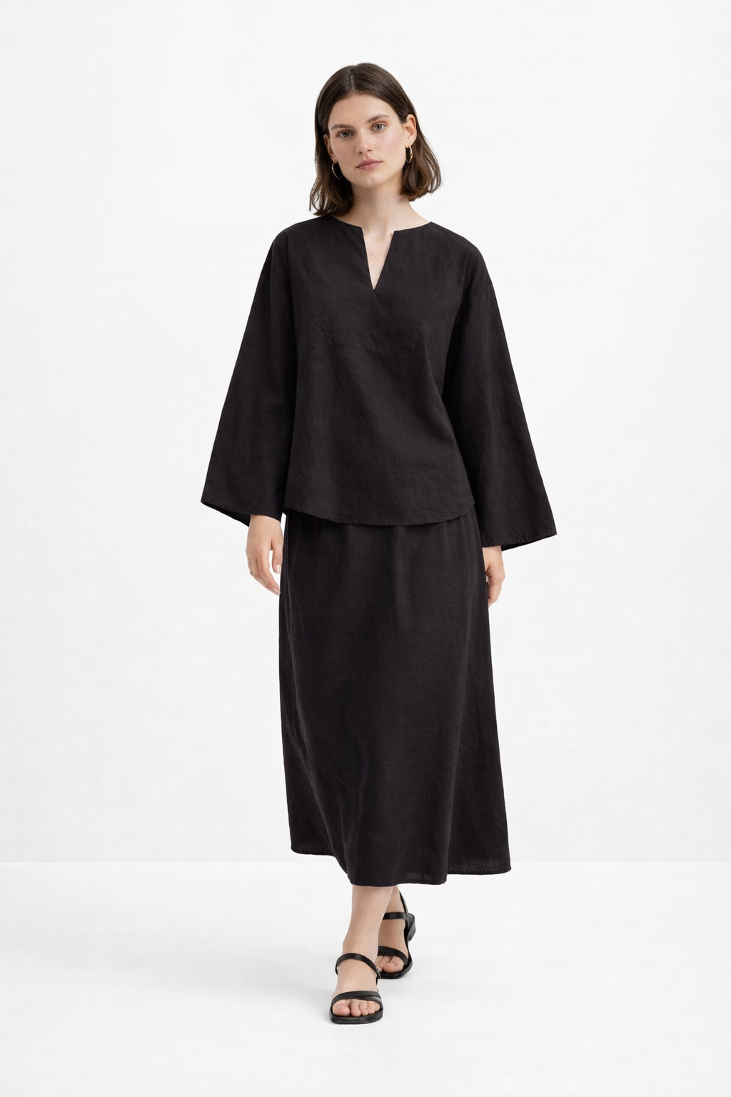 Model walking in Eclipse Black Linen Set crafted from pure linen with a relaxed silhouette and elegant drape.