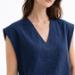 Close-up of Ira Neel linen vest showing V-neckline, dropped shoulder, and natural linen texture