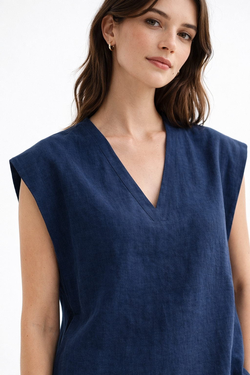 Close-up of Ira Neel linen vest showing V-neckline, dropped shoulder, and natural linen texture