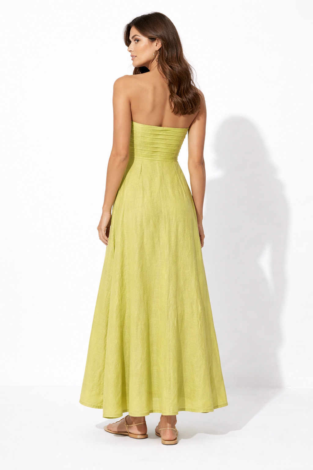 Back view of Lime Aura Linen Dress with clean strapless back and flowing hem