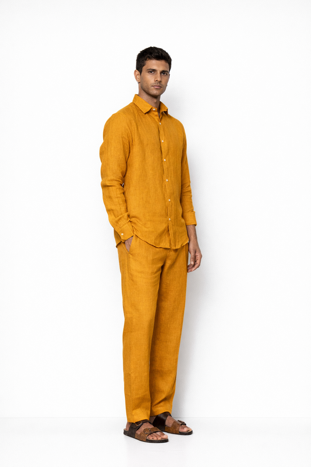Side profile of mustard linen pants for men by LININ