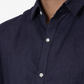 Close-up of navy blue linen fabric texture on men’s shirt by LININ