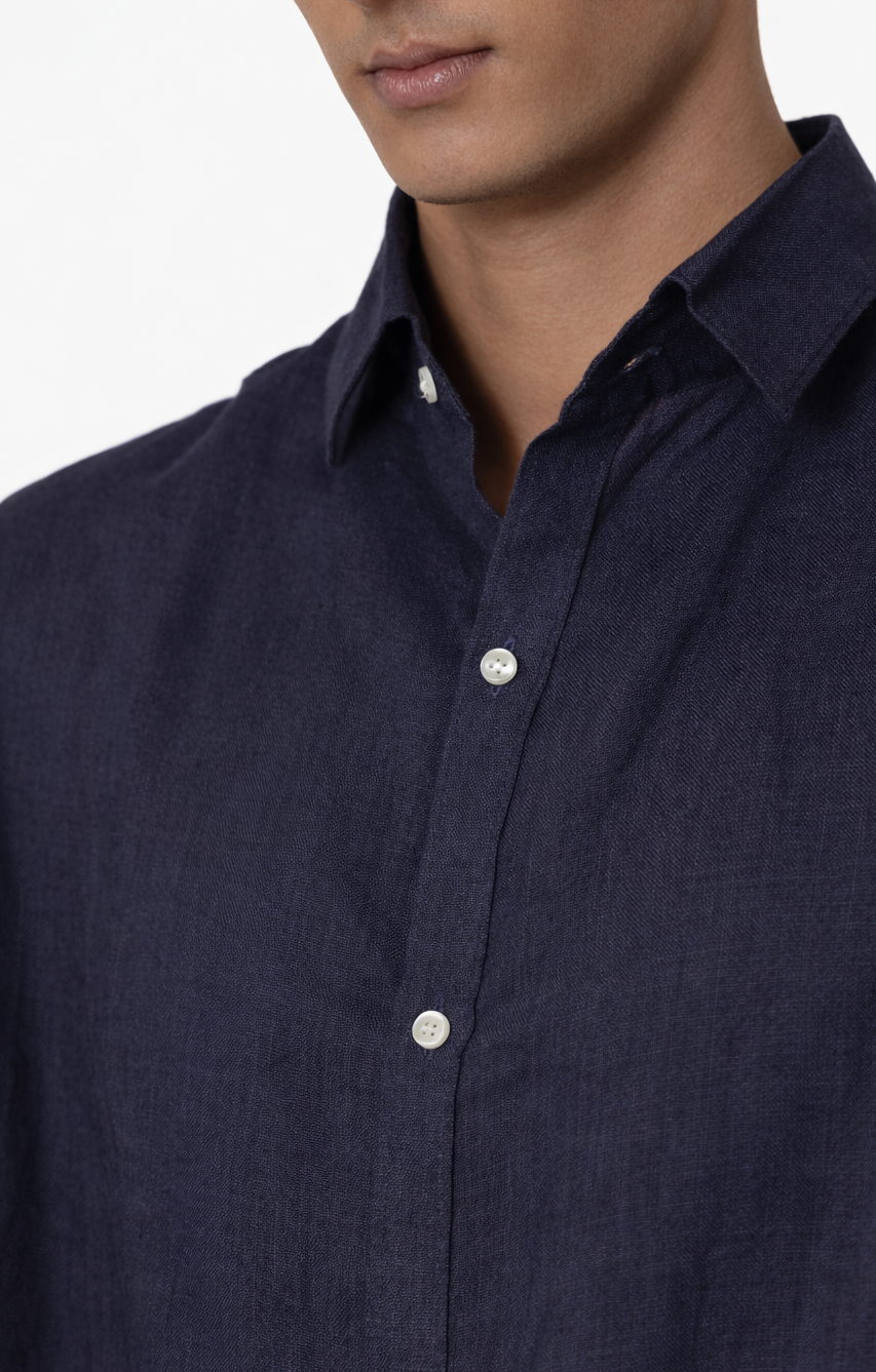Close-up of navy blue linen fabric texture on men’s shirt by LININ