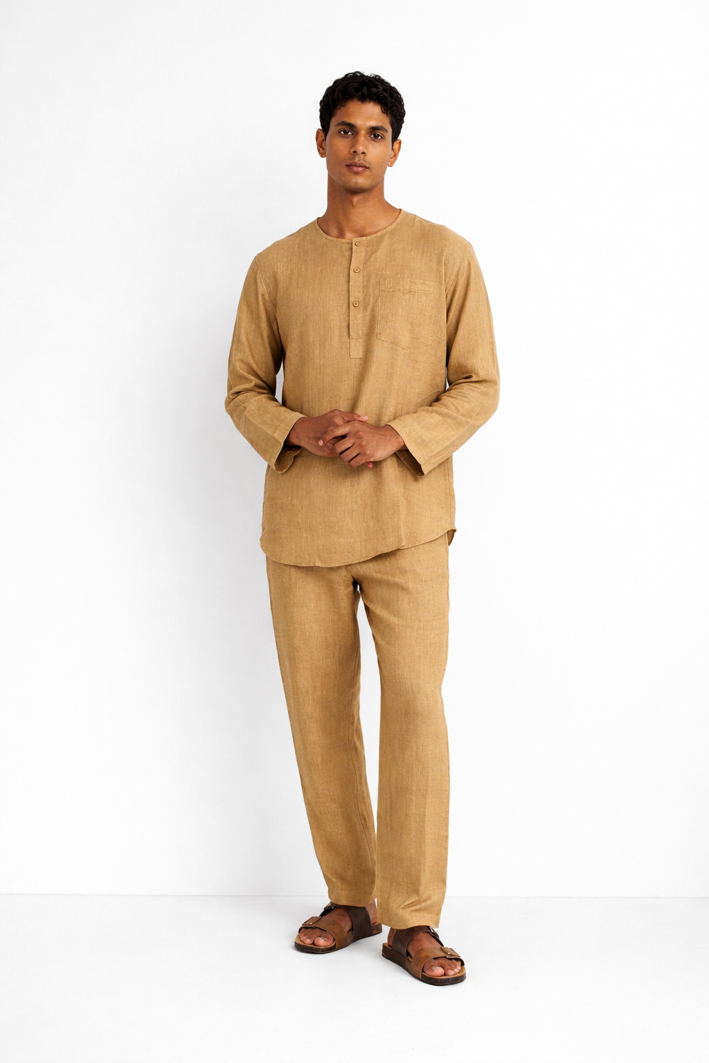 Model wearing ochre linen men’s short kurta set from LININ