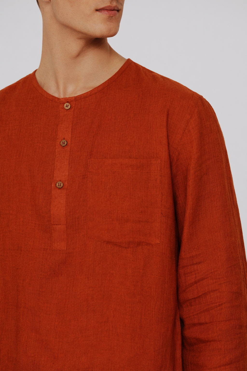 Close-up of rust linen fabric texture on men’s short kurta set by LININ