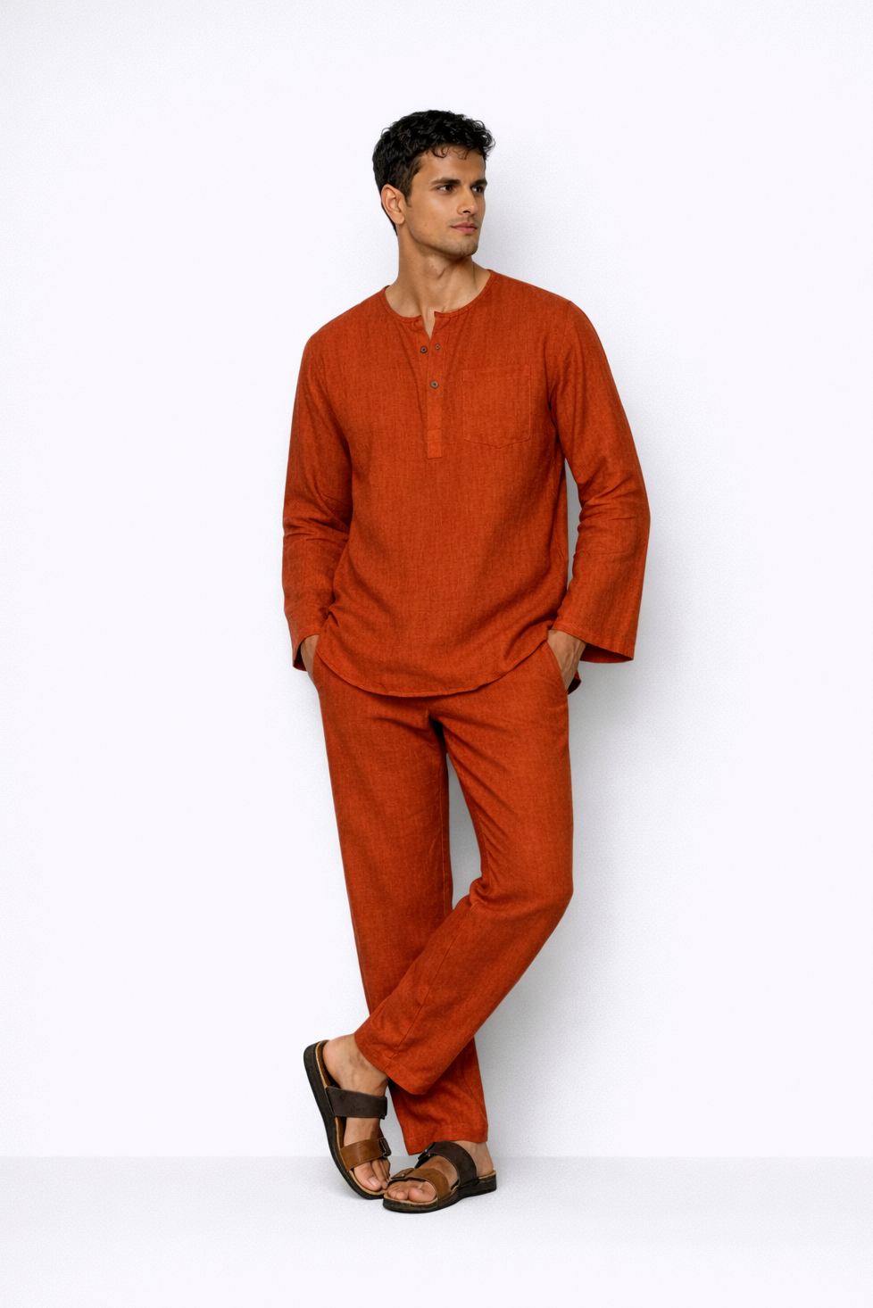 Model wearing rust linen short kurta set for men from LININ