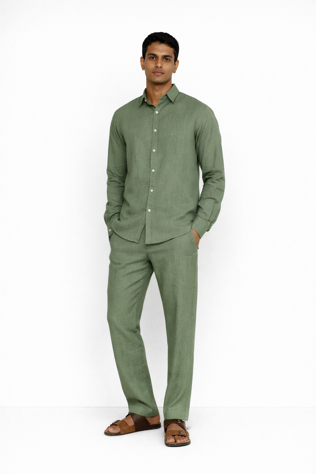 Model wearing sage green linen pants for men from LININ