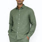 Close-up of linen fabric texture on sage green men’s shirt by LININ