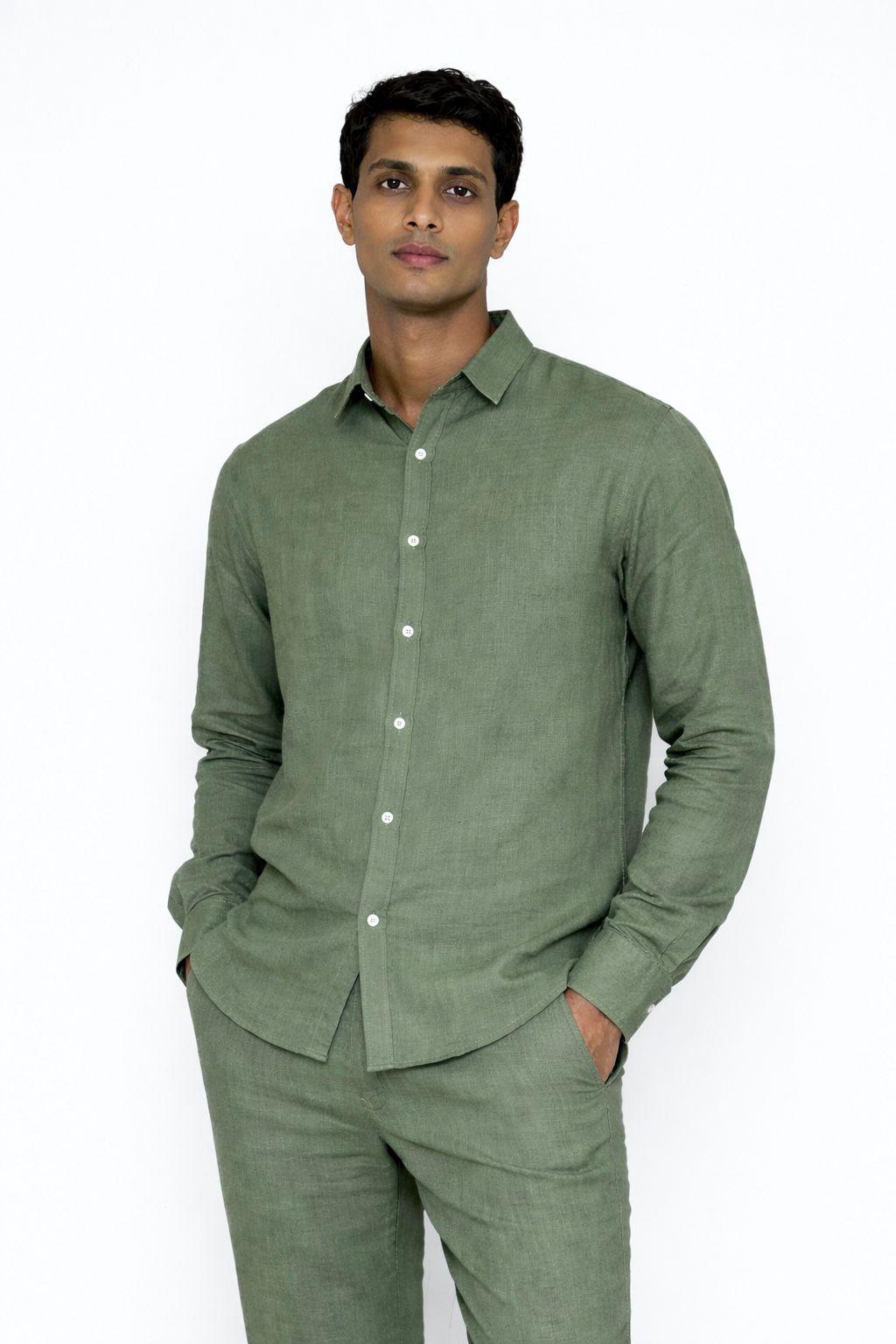 Close-up of linen fabric texture on sage green men’s shirt by LININ