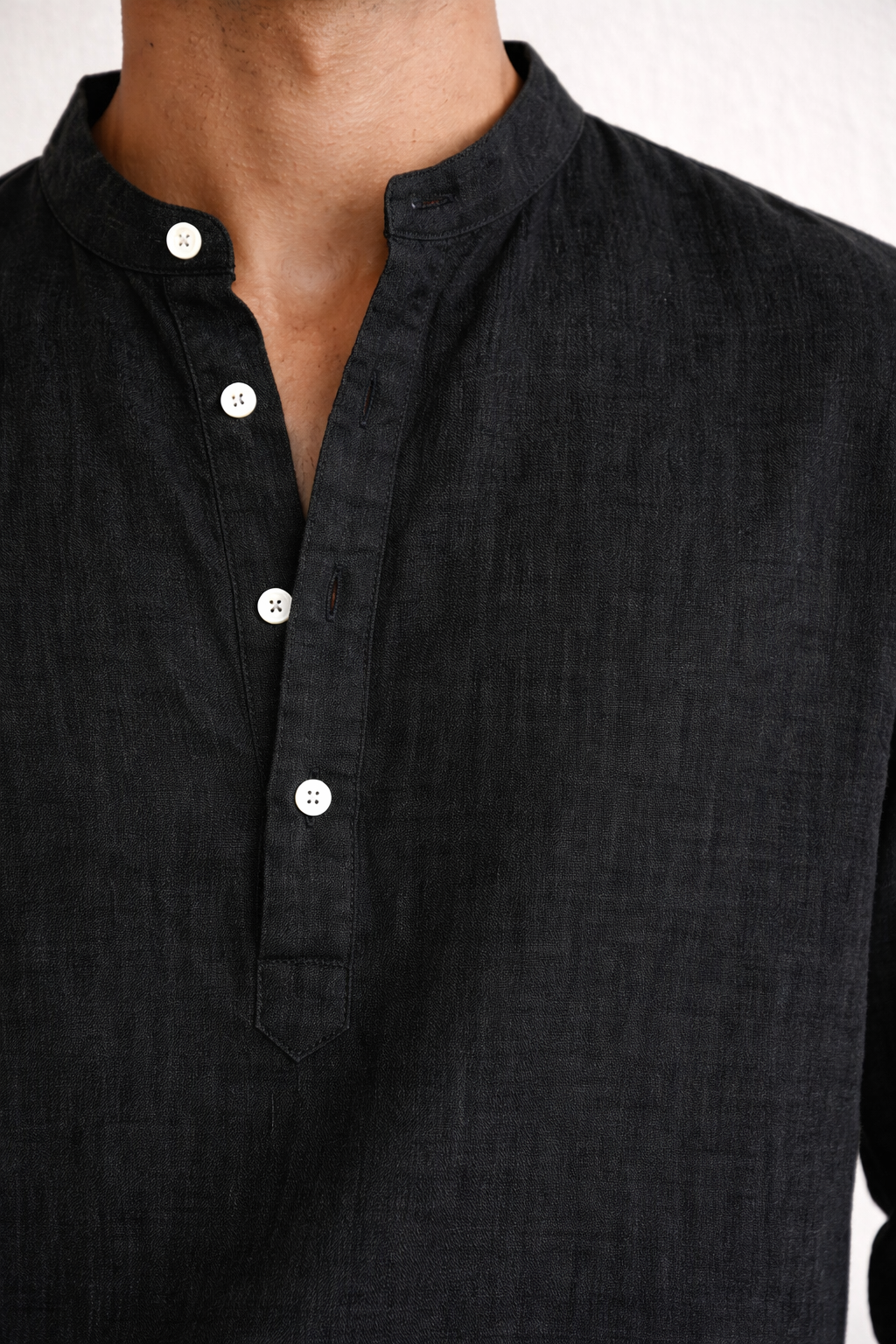 Close-up of pure linen fabric texture on midnight black short kurta