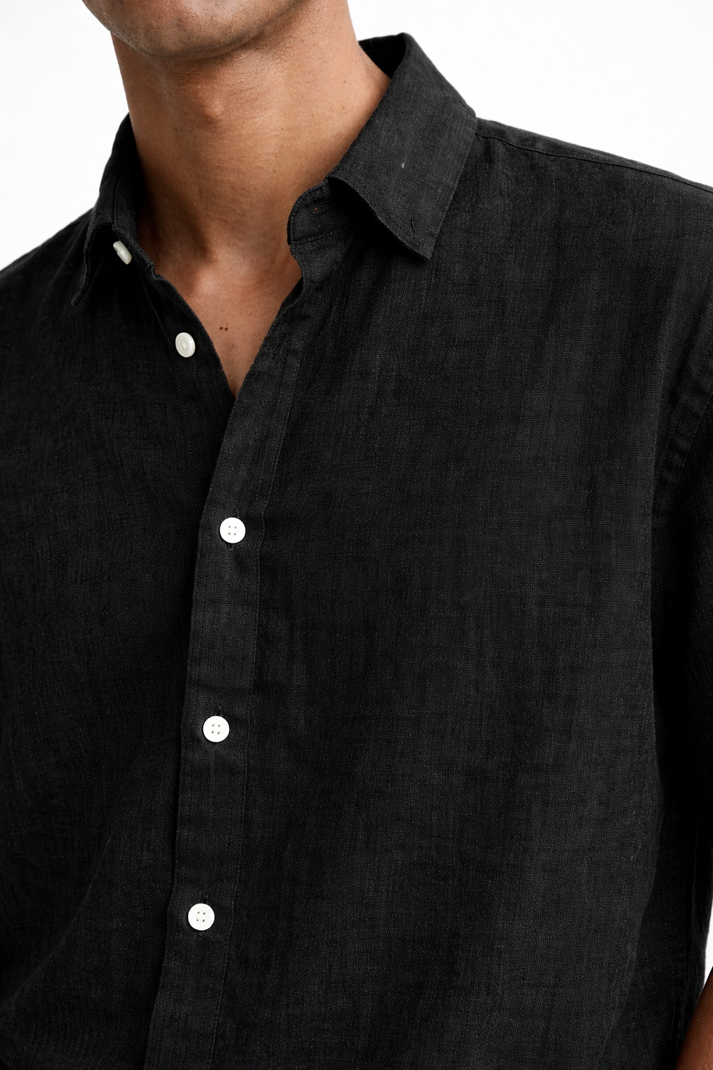 Close-up of premium midnight black linen fabric texture on men’s shirt