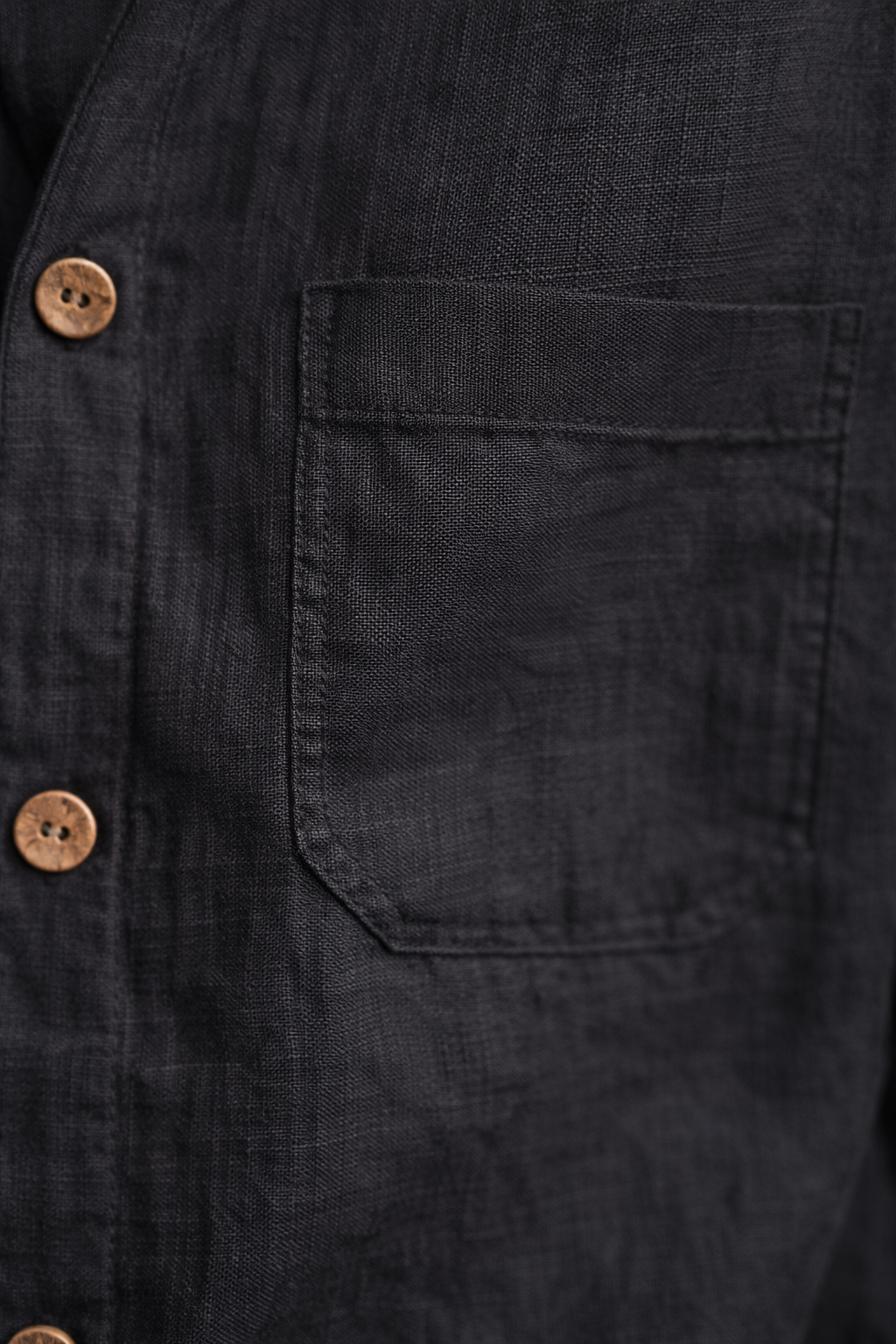 Close-up of midnight black pure linen fabric showing natural weave and texture