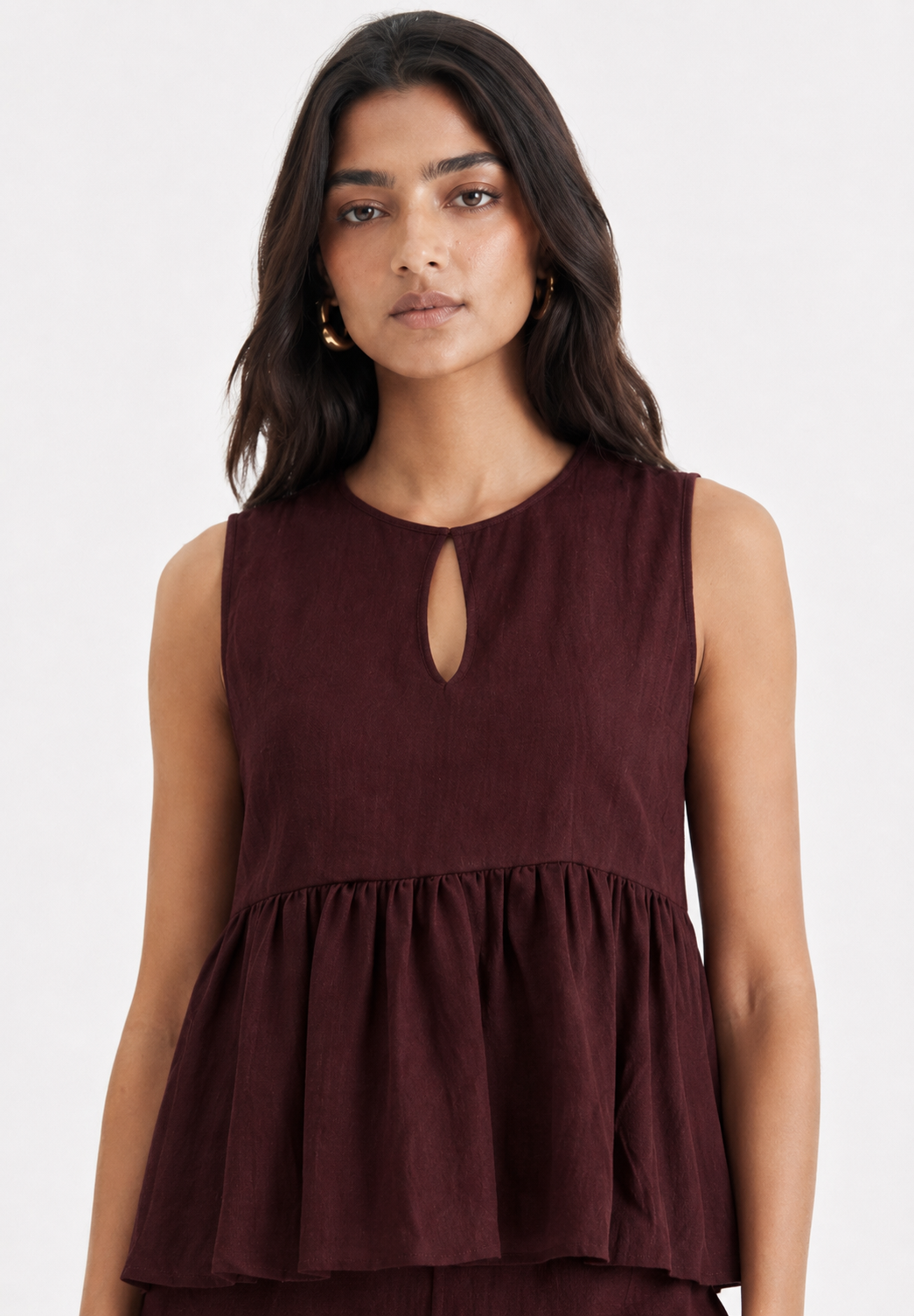 Close-up of Mulberry Muse linen peplum top with keyhole neckline