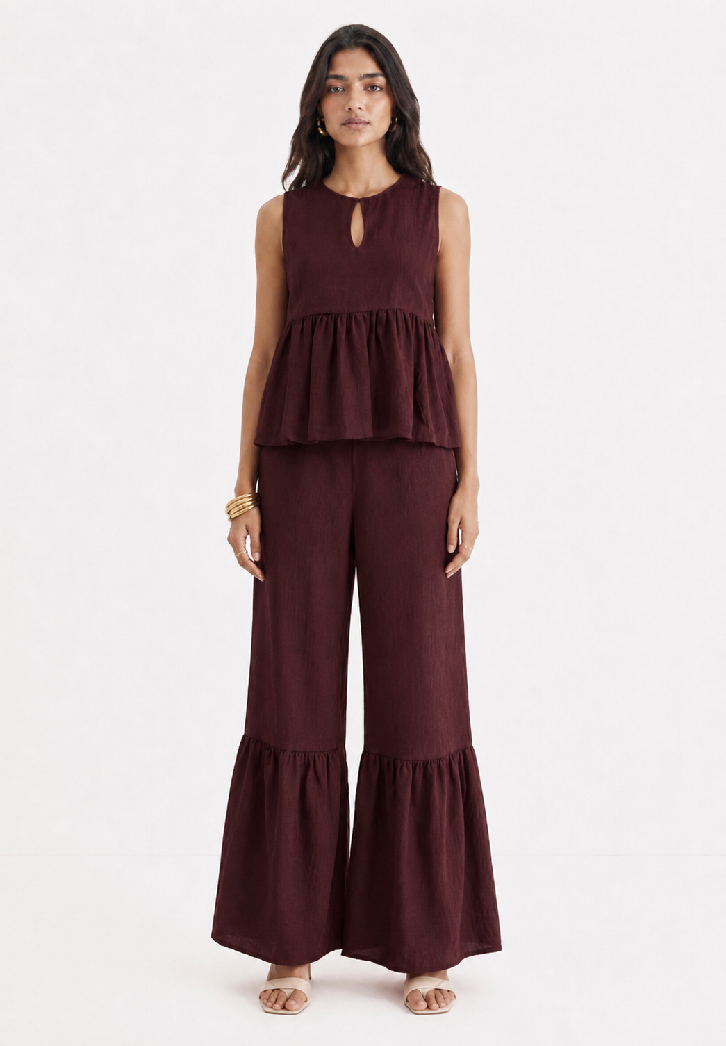 Woman wearing Mulberry Muse pure linen co-ord set in rich mulberry colour - front