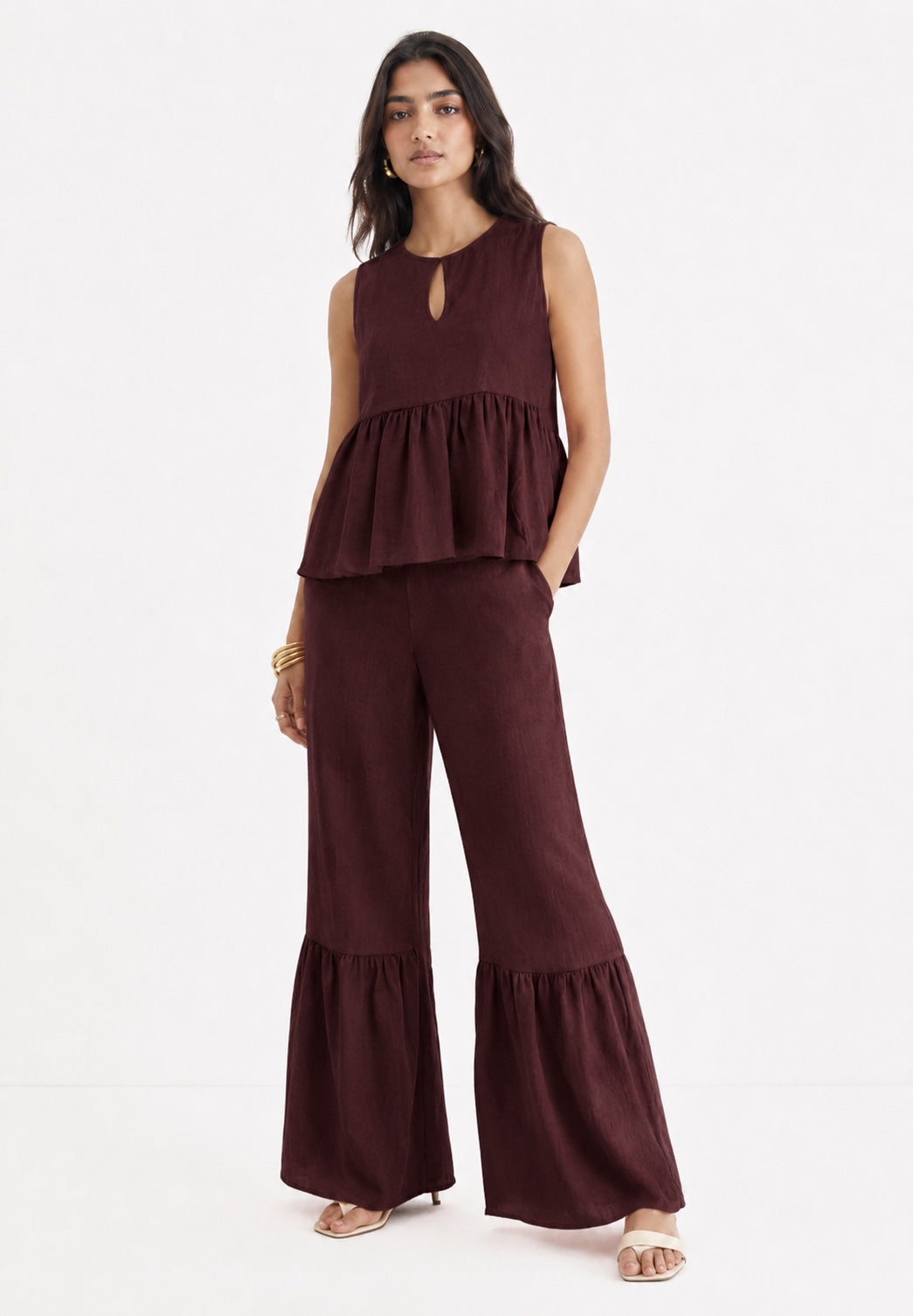 Woman wearing Mulberry Muse pure linen co-ord set in rich mulberry colour