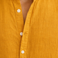 Close-up of pure linen fabric texture on mustard yellow short kurta