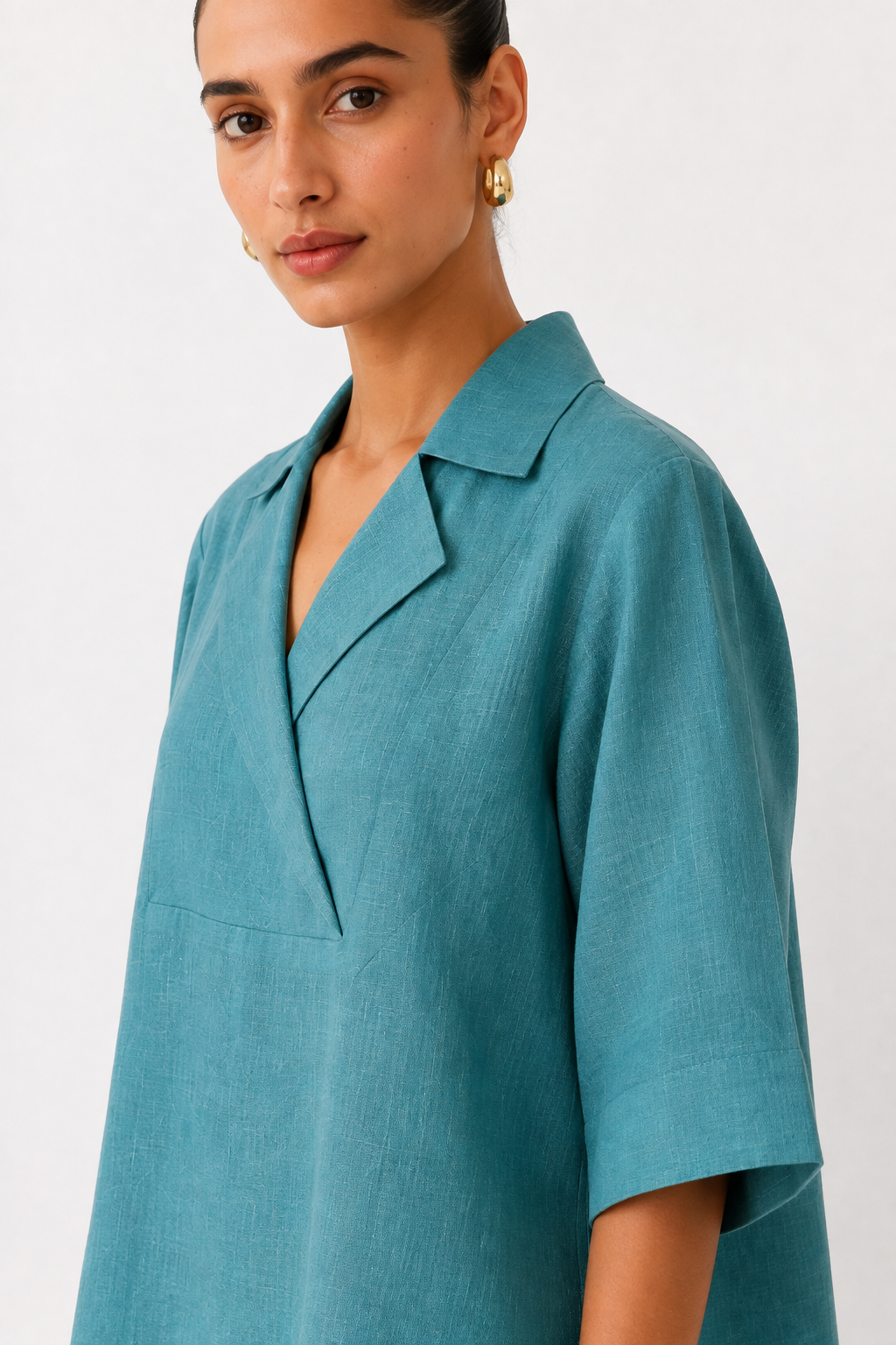 Nivara teal linen top with notched collar and V-neck detail