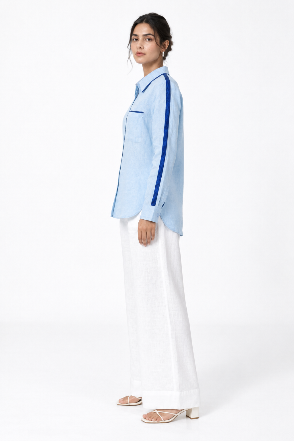 Side view of ocean blue linen shirt with navy satin sleeve detailing