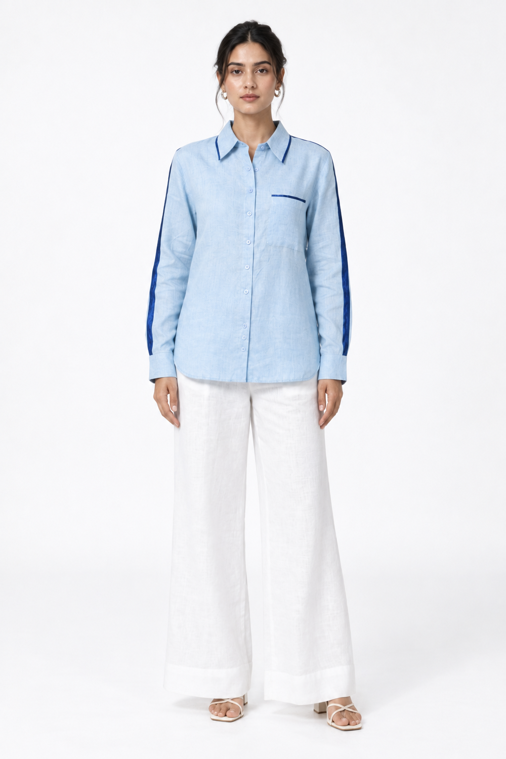 Ocean blue linen shirt with navy satin detailing styled with white linen trousers