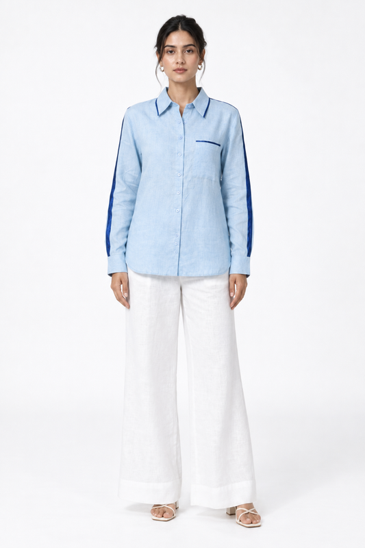 Ocean blue linen shirt with navy satin detailing styled with white linen trousers