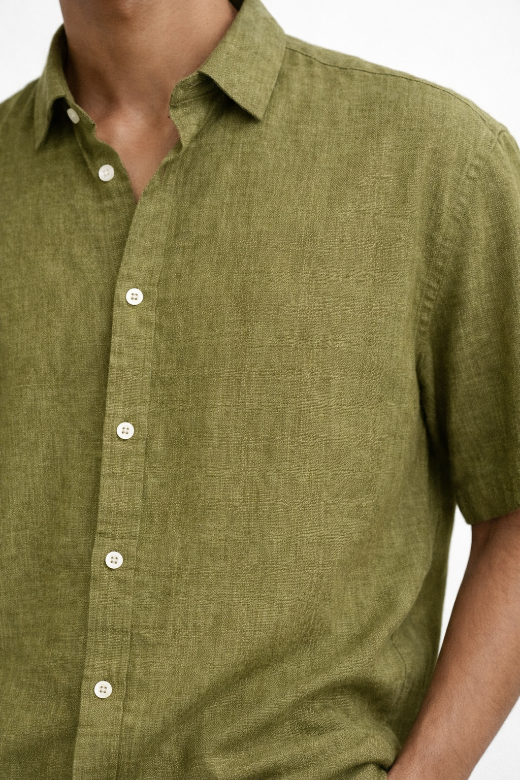 Close-up of olive green linen fabric texture on men’s shirt