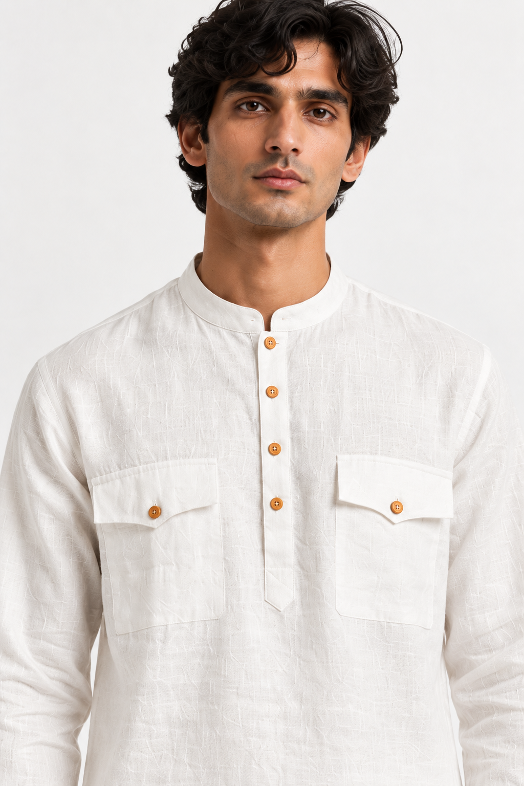 Close-up of the Safed white linen kurta highlighting its natural fabric texture, mandarin collar, wooden-toned buttons, and dual chest pockets.