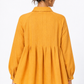 Back detail of Sarson women's mustard linen shirt with pleated flare