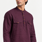 Close-up of the Shaam men's plum kurta featuring a band collar, wooden-tone buttons and flap chest pockets