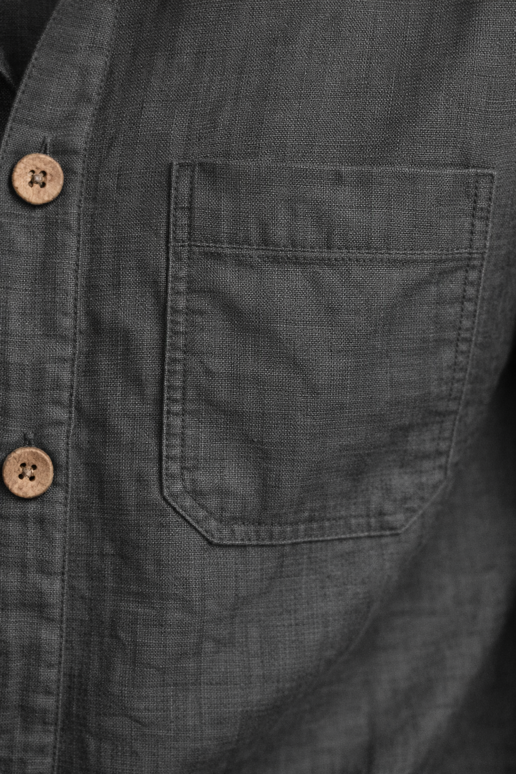 Close-up of steel grey pure linen fabric showing natural weave and breathable texture