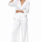 Model posing in Taj Safa Linen Set featuring relaxed linen top and wide-leg pants with side pockets.