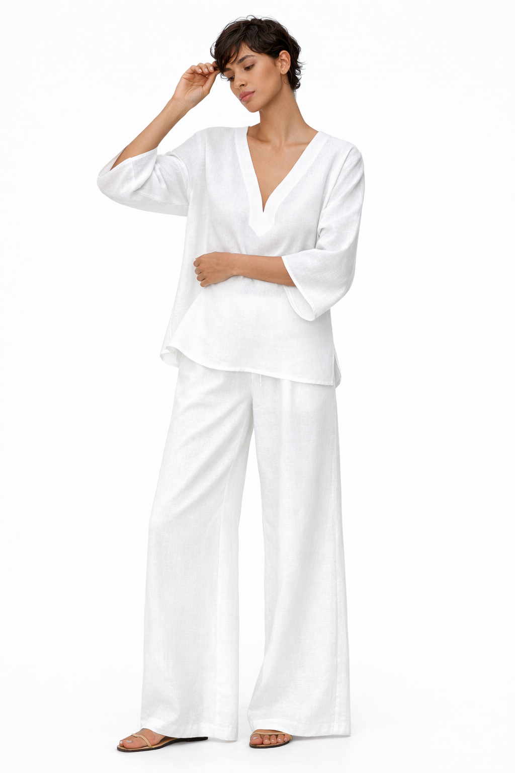 Model posing in Taj Safa Linen Set featuring relaxed linen top and wide-leg pants with side pockets.