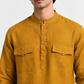 Close-up of the Zafran mustard linen kurta featuring a band collar, wooden-tone buttons, and dual flap chest pockets.