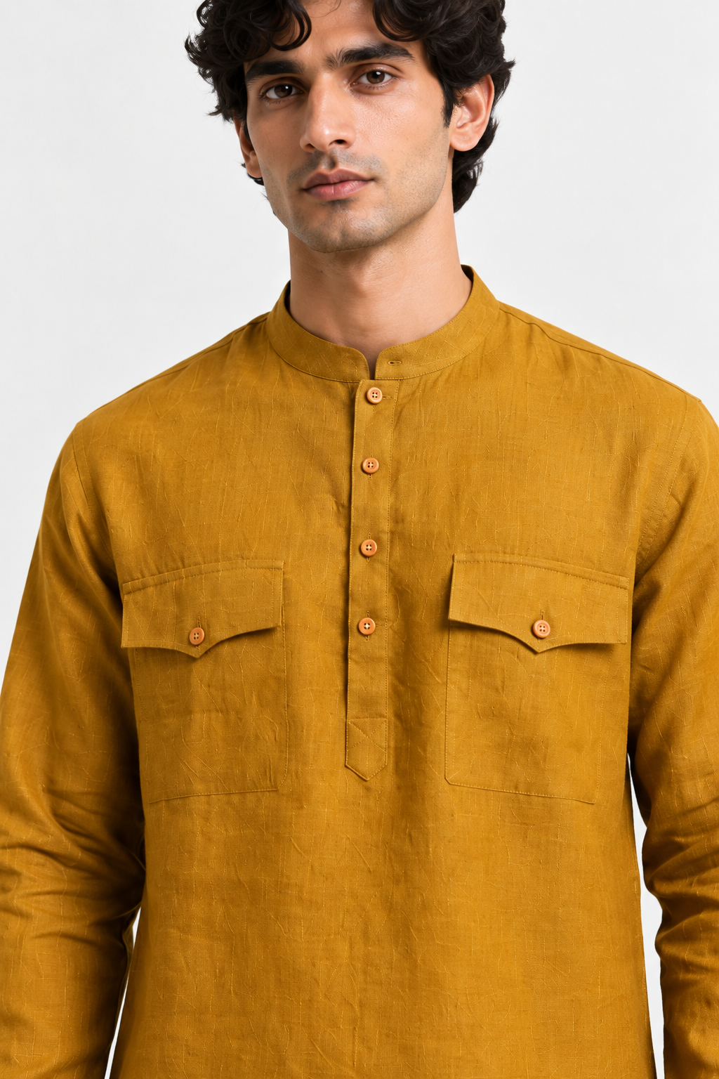 Close-up of the Zafran mustard linen kurta featuring a band collar, wooden-tone buttons, and dual flap chest pockets.