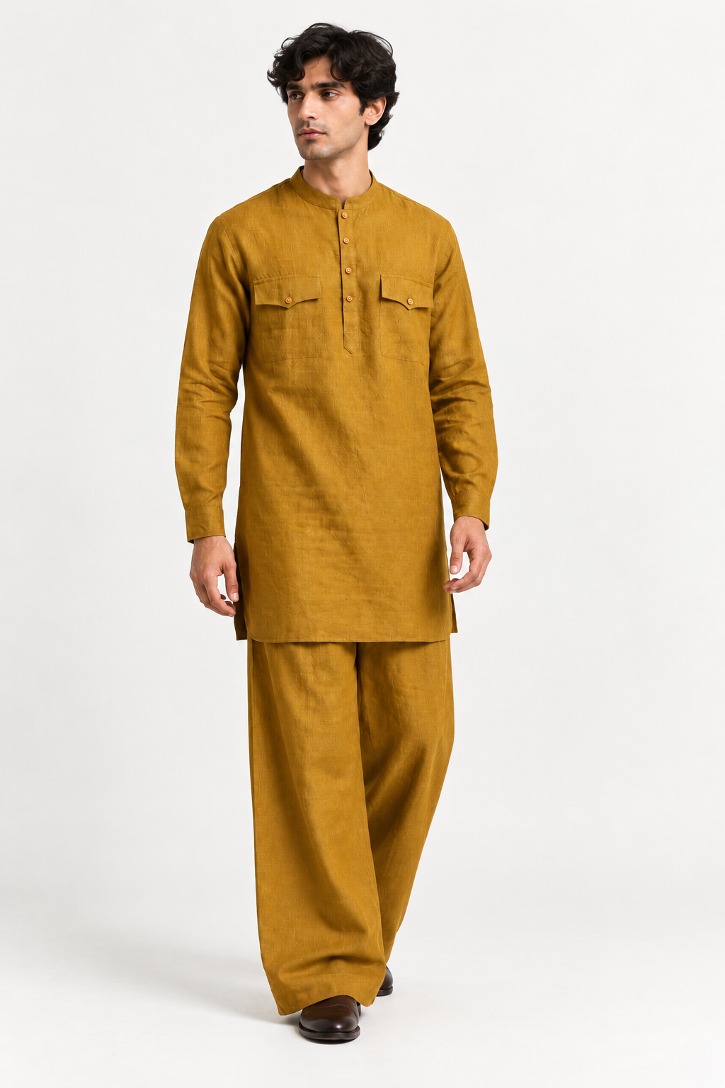 Model wearing the Zafran marigold mustard linen kurta set with a relaxed silhouette and wide-leg trousers.
