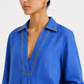 Close-up of Ziya linen top showing V-neck and lemon yellow chawal taka detailing